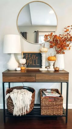 a console table with two wicker baskets and a mirror on the wall above it