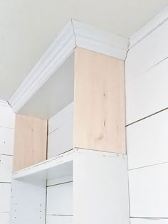 the corner of a room with white painted wood