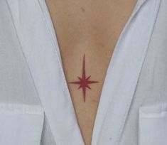 a woman with a red star tattoo on her chest