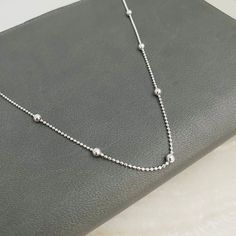 "Our 925 silver satellite link chain is delicate; it does not need a pendant to shine due to the small and large ball links, this Chain Necklace with Silver Beads is ideal for wearing alone on the neck, but if you prefer, you can use it with other chains that will look great on you, it has long durability; It is waterproof, it is available in three sizes, 16\", 18\" and 20\" for your best choice. You will love having one of these. ITEM DESCRIPTION: Silver Bead Chain Necklace Material: 925 Silver Elegant Silver Chain Necklace With Adjustable Chain, Silver Chains For Women Neck, Formal Stainless Steel Silver Chain Necklace, Silver Satellite Chain Necklace Minimalist Style, Silver Necklace With Satellite Chain And Round Beads, Silver Chain Necklace With Delicate Round Beads, Dainty Silver Chain Necklace With Round Beads, Silver Elegant Chain Necklace With Polished Beads, Silver Minimalist Satellite Chain Necklace