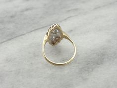 This sweet ring is a bit of an enigma. The style borders the Mid Century and Retro Eras, but falls solidly into neither. The bright cut of the original, high quality diamonds, however, tell us that this is 20th Century in origin, and in excellent condition! Metal: 14K Yellow and White Gold Gem: 3 Diamonds totaling .10 Carat, I in Color, VS in Clarity Gem Measurements: 1.9 mm, Round Ring Size: 6.50 Marks: "14K" Stamped on the inside band Dinner Ring, Cocktail Dinner, Sweet Ring, Retro Era, Round Rings, Quality Diamonds, Eternity Bands, Statement Rings, Heart Ring