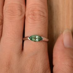 It is a green sapphire ring. The main stone is 5 mm*10 mm marquise cut.weight about 1.34 carats. The basic metal is sterling silver and plated with rhodium/14k white gold/14k rose gold/14k yellow gold You can also go to my shop Home for more elegant rings: https://www.etsy.com/shop/godjewelry?ref=hdr_shop_menu Customization is always welcome and please feel free to contact with me if you have any design ideas! Marquise Emerald Ring For May Birthstone, Classic Marquise Cut May Birthstone Jewelry, Marquise Cut Sapphire Promise Ring, Marquise Cut Emerald Promise Ring, 14k White Gold Marquise Rings, Marquise Cut Sapphire Ring For Anniversary, Sterling Silver Marquise Cut Sapphire Ring, Marquise Sapphire Ring As Gift, Marquise Cut Sapphire Ring In Sterling Silver