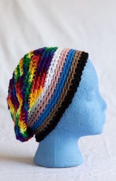 This crochet slouchy hat is inspired by the Progress Pride Flag created by Daniel Quasar and features a rainbow back with a white, pink, blue, brown, and back band. Made for all people! The acrylic yarn is low maintenance and can be worn in both cool and warm climates. This hat is easy to care for: wash on machine gentle with cold water and tumble dry on low to dry.  10% of this purchase will be donated to the Zebra Coalition, a network of organizations supporting LGBTQ+ youth in the Orlando, FL area. Pride Flag Crochet, Bonnet En Crochet, Supporting Lgbtq, Progress Pride Flag, Crochet Slouchy Hat, Bonnet Crochet, Slouch Hat, Slouchy Hat, Pride Flag