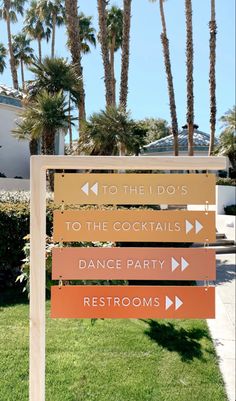 a sign in front of some palm trees and buildings with the words to the do's to the cocktails dance party restrooms