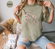 This Cherry Blossom Branch Comfort Colors T Shirt is great for spring, summer, fall or anytime you need an artistic reminder to stay positive, grow and shine! The design features a beautiful Sakura tree branch. Purchase for yourself or as a gift for your favorite gardener, flower lover or nature lover. Comfort Colors introduces its garment-dyed t-shirt; a fully customizable tee made 100% with ring-spun cotton. The soft-washed, garment-dyed fabric brings extra coziness to your wardrobe while the relaxed fit makes it an excellent daily choice. The double-needle stitching throughout the tee makes it highly durable while the lack of side-seams helps the shirt retain its tubular shape. .: 100% ring-spun cotton .: Medium fabric (6.1 oz/yd² (206.8 g/m .: Relaxed fit .: Sewn-in twill label Long Sleeve Floral Print T-shirt For Spring, Trendy Crew Neck Spring Shirt, Spring Crew Neck Shirt With Relaxed Fit, Trendy Crew Neck Shirt For Spring, Relaxed Fit Crew Neck Shirt For Spring, Spring Floral Embroidery Relaxed Fit Shirt, Casual Floral Embroidered Shirt For Spring, Spring Green T-shirt With Floral Embroidery, Green T-shirt With Floral Embroidery For Spring