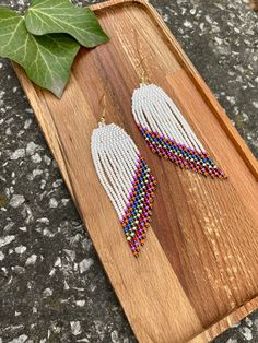 Pearl white beaded fringe earrings, Angel wings seed bead earrings dangle boho earrings native beaded earrings chandelier earrings ♥𝑇ℎ𝑒 𝑝𝑎𝑡𝑡𝑒𝑟𝑛 𝑜𝑓 𝑡ℎ𝑖𝑠 𝑒𝑎𝑟𝑟𝑖𝑛𝑔 𝑖𝑠 𝑐𝑟𝑒𝑎𝑡𝑒𝑑 𝑏𝑦 𝐾𝑎𝑍𝑒𝐵𝑒𝑎𝑑𝐽𝑒𝑤𝑒𝑙𝑟𝑦 ♥𝑀𝑎𝑑𝑒 𝑢𝑠𝑖𝑛𝑔 𝑓𝑟𝑒𝑒ℎ𝑎𝑛𝑑 𝑏𝑒𝑎𝑑𝑖𝑛𝑔 𝑤𝑜𝑣𝑒𝑛 𝑡𝑒𝑐ℎ𝑛𝑖𝑞𝑢𝑒𝑠 𝑤𝑖𝑡ℎ 𝑠𝑡𝑟𝑜𝑛𝑔 𝑠𝑦𝑛𝑡ℎ𝑒𝑡𝑖𝑐 𝑡ℎ𝑟𝑒𝑎𝑑. ♥𝑇ℎ𝑒 𝑠𝑖𝑧𝑒 𝑜𝑓 𝑡ℎ𝑒 𝑠𝑒𝑒𝑑 𝑏𝑒𝑎𝑑𝑠 𝑢𝑠𝑒𝑑 𝑖𝑠 2 𝑚𝑖𝑙𝑙𝑖𝑚𝑒𝑡𝑒𝑟𝑠 𝑎𝑛𝑑 𝑏𝑒𝑎𝑑𝑠 𝑎𝑟𝑒 ℎ𝑖𝑔ℎ 𝑞𝑢𝑎𝑙𝑖𝑓𝑖𝑒𝑑. ♥𝐴𝑙𝑙 𝑡ℎ𝑒 ℎ𝑜𝑜𝑘𝑠 𝑢𝑠𝑒𝑑 𝑖𝑛 𝑜𝑢𝑟 𝑗𝑒𝑤𝑒𝑙𝑟𝑦 𝑎𝑟𝑒 24 𝑘 𝑔𝑜𝑙𝑑 𝑝𝑙𝑎𝑡𝑒𝑑 𝑎𝑛𝑑 ℎ𝑦𝑝𝑜𝑎𝑙𝑙𝑒𝑟𝑔𝑒𝑛𝑖𝑐. ♥𝑇ℎ𝑒𝑠𝑒 𝑎𝑟𝑒 𝑣𝑒𝑟𝑦 𝑙𝑖𝑔ℎ𝑡 𝑒𝑎𝑟𝑟𝑖𝑛𝑔𝑠 𝑡ℎ𝑎𝑡 𝑦𝑜𝑢 𝑐𝑎𝑛 𝑤𝑒𝑎𝑟 𝑎𝑙𝑙 𝑑𝑎𝑦 𝑤𝑖𝑡ℎ𝑜𝑢𝑡 ℎ𝑢𝑟𝑡𝑖𝑛𝑔 𝑦𝑜𝑢𝑟 𝑒𝑎𝑟! The only access Beaded Fringe Dangle Earrings, White Tassel Earrings With Colorful Beads, Adjustable White Tassel Earrings With Colorful Beads, White Beaded Adjustable Chandelier Earrings, White Dangle Tassel Earrings For Festivals, White Chandelier Earrings With Dangling Beads For Festivals, Bohemian White Beaded Chandelier Earrings, White Colorful Beads Drop Tassel Earrings, White Colorful Beads Tassel Drop Earrings