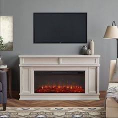 a living room with a fireplace and tv on the wall