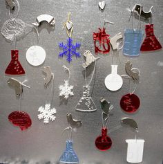 christmas ornaments are hanging on a silver surface