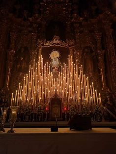 an altar with candles lit up in front of it