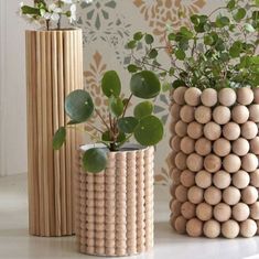 three wooden vases with plants in them