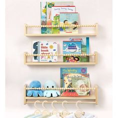 three wooden shelves with books and toys on them