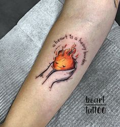 a person with a tattoo on their arm that says, there is a fire in the heart