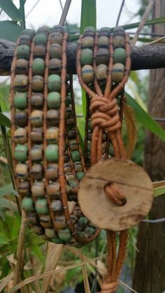 a bunch of beads hanging from a tree branch