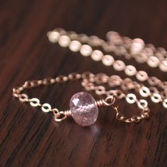 "This gemstone choker necklace is a dainty, pretty choice that looks great worn alone or layered with other chains. In this simple style, a real lepidocrocite gemstone is centered on lightweight, rose gold-filled chain. Lepidocrocite is known for its unique speckles and markings, and this particular stone is a soft pink/plum colour. The stone measures about 7mm in diameter. Little rose gold beads connect the lobster clasp. This necklace is approx. 15.25\" (38.7cm) long, and is pictured on a life Dainty Rose Gold Wire Wrapped Necklaces, Minimalist Rose Gold Wire Wrapped Necklace, Jewelry Layering Necklace, Pink Gold Jewelry, Gemstone Choker Necklace, Jewelry Layering, Mandala Necklace, Gemstone Choker, Rose Gold Beads