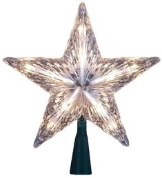 a lighted star on top of a green pole