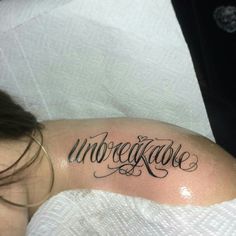 a woman with a tattoo on her arm that reads unreggaged and has the word