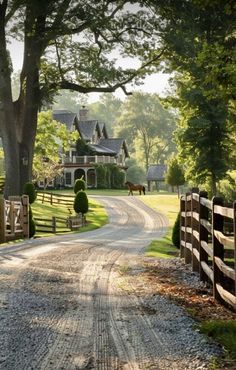 a dirt road leading to a large house