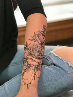 a woman with a rose tattoo on her arm