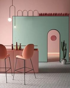 two chairs and a table in front of a pink wall with an arch on it