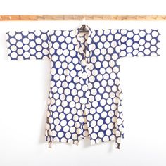 a blue and white polka dot kimono hanging on a clothes line