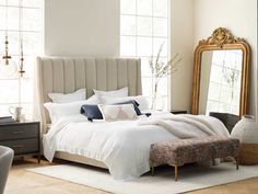 a bedroom with a large bed and mirror