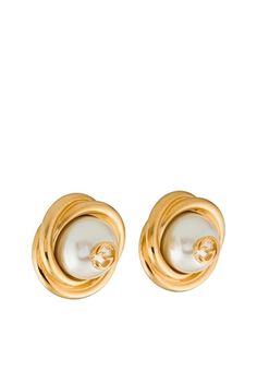 These faux pearl clip-on earrings offer a polished gold rendition of Gucci's iconic GG logo - inspired by an archival design from the '70s. Crafted in Italy, each of these earrings pays homage to Gucci’s proud brand heritage with a small Double G logo perched on a lustrous glass pearl. Twisted, gold-tone metal edging adds a sculptural finish, while the oversized silhouette recalls classic vintage styles. Oversized stud earrings Gold-tone metal Large glass pearls Twisted edging Central Double G l Luxury Gucci Earrings For Evening, Gucci Luxury Evening Earrings, Gucci Round Earrings For Formal Events, Gucci Round Earrings For Formal Occasions, Gucci Gold Jewelry For Pierced Ears, Gucci Designer Gold Earrings, Classic Gucci Earrings, Gucci Gold Earrings For Formal Occasions, Classic Gucci Earrings As Gift