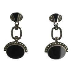 This is part of Chairish’s Fine Jewelry assortment.  A beautiful pair of black onyx and sterling silver Art Deco style dangle earrings, circa mid to late-20th century. A great pair to dress up or down. Each are marked on back 'Sterling' as shown in last three images. Excellent condition as shown in images. No issues. Dimensions: 1.5" Long. Black Art Deco Earrings For Evening, Classic Black Enamel Earrings For Formal Occasion, Black Oval Earrings For Formal Occasions, Vintage Black Oval Earrings, Black Oval Vintage Earrings, Black Enamel Sterling Silver Drop Earrings, Classic Black Enamel Earrings For Evening, Sterling Silver Black Enamel Drop Earrings, Formal Pierced Onyx Earrings