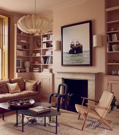 a living room filled with furniture and a fire place in front of a painting on the wall