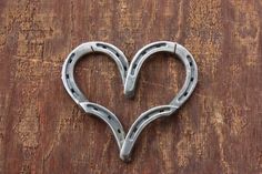 a heart shaped metal object sitting on top of a wooden table