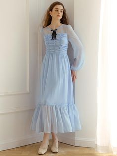 Romantic maxi dress that made of chiffon material in sky blue color. Featuring the see-through sleeves and neckline, shirring detail at the bodice, and flowy skirt with ruffle hem. The black velvet ribbon at the neckline also elevated the feminine mood.  - See-through design at neckline, sleeves, and hem- Shirring detail at the bodice- Long, flowy skirt with ruffle hem- Black velvet laced ribbon at the neckline- Zipper closure at back Maxi Chiffon Dress With Sheer Sleeves, Casual Ruffled Maxi Chiffon Dress, Casual Ruffled Maxi Length Chiffon Dress, Casual Ruffled Chiffon Maxi Dress, Maxi Length Chiffon Dress With Ruffles For Casual Wear, Chiffon Midi Dress With Sheer Sleeves, Long Chiffon Dress With Ruffles, Long Sleeve Ruched Chiffon Maxi Dress, Long Sleeve Ruched Chiffon Dress