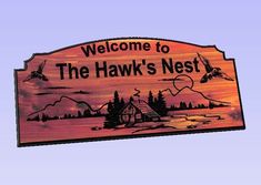 a wooden sign that says welcome to the hawk's nest