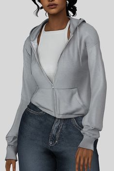 a woman wearing a gray hoodie and jeans