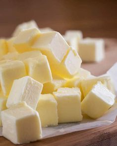 cubes of cheese sitting on top of white paper