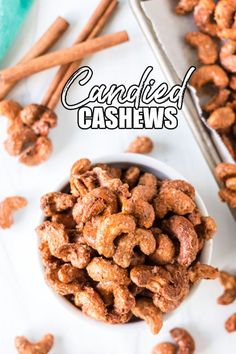 a white bowl filled with candied cashews next to cinnamon sticks