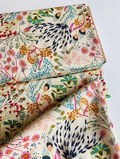 a close up of a flowered fabric with different colors and designs on it's surface