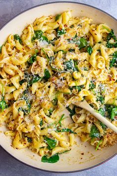 pasta with spinach and parmesan cheese in a pan