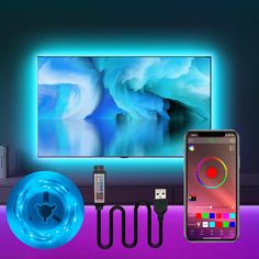 an image of a cell phone and other electronics in front of a tv with neon lights