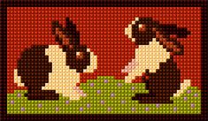 the cross stitch pattern shows two cows sitting on grass, one is brown and white