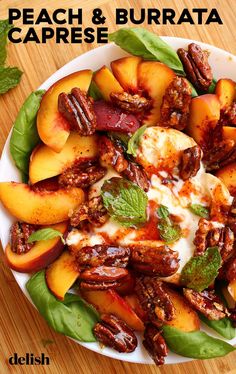 peach and burrata caprese salad on a white plate with mint garnish