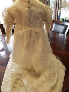 "FREE SHIPPING IN THE U.S. and reduced shipping rates for International orders. This beautiful gown is a wedding dress conversion, but it can be made from similar fabric from my shop. Satin bodice with puffed sleeves and a scalloped lace edge. Skirt also has the scalloped lace edge. Satin ribbon around the waist, secured with loop fasteners at the side seams, bow can tied in front or back. Bridal looping and satin buttons close the back. Gown is made heirloom quality with French seams and hand f Elegant Organza Gown For Pageants, Elegant Ball Gown Wedding Dress For Ceremony, Cream Floor-length Gown For Ceremony, First Communion Lace Ball Gown Wedding Dress, Fitted Organza Pageant Dress For Wedding, Lace Bodice Ball Gown Wedding Dress For First Communion, Cream Pageant Gown With Lace Bodice, Wedding Gown With Lace Bodice And Organza, Cream Gown With Lace Bodice For Pageants