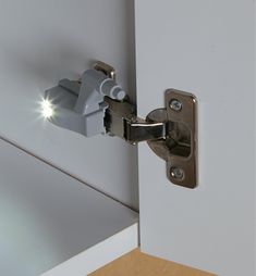 an open door with a light shining on the handle and side view mirror behind it