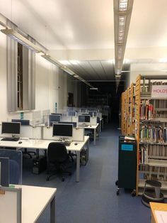 an empty library with desks and bookshelves