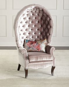 an ornate chair in front of a white wall