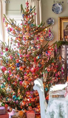 a decorated christmas tree in the corner of a room