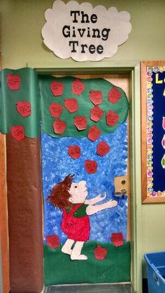 a classroom door decorated with the giving tree