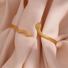 For all our mystic babes out there. This Gold Snake Wrap Bracelet features a slithering snake design that wraps around your wrist creating an elegant yet edgy allure. DETAILS & SIZE Finish: 18k gold plate Materials: 316L Stainless Steel Measurements: Circumference: 8" (can be shaped to fit smaller or larger wrists); Width: 5mm Waterproof, tarnish-resistant, and nickel free Shop Bracelets for more options to layer this with! Adjustable Gold Metal Snake Ring, Elegant Gold Snake Ring, Gold Snake-shaped Jewelry For Party, Elegant Adjustable Metal Snake Ring, Gold Snake-shaped Party Jewelry, Adjustable Trendy Snake Jewelry, Flexible Gold Snake Bracelet, Adjustable Gold Snake-shaped Jewelry, Adjustable Gold Snake Bracelet