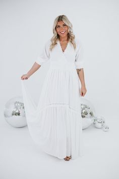 Instantly become the most adored, this stunning maxi features a cinched waistline, cuffed mid-length sleeves, full lining, and intricate lace detailing throughout. The most whimsical piece for all seasonal occasions! Neckline: Lace V Fabric: 100% polyester; Lining: 100% Polyester Details: Cinched waistline, lined, mid-length cuffed sleeve, lace detailing, adjustable tie back Fit: True to size, if in between sizes we recommend sizing down! - Arms: Relaxed; Mid-length cinched sleeve- Chest: Relaxe Bohemian Off-white Maxi Dress For Day Out, Casual White Maxi Dress With 3/4 Sleeves, White V-neck Maxi Dress With Lace Trim, White Stretch A-line Maxi Dress, Bohemian White Maxi Dress With Hollow-out Details, Mid Length Sleeves, Everyday Chic, Chic Boutique, Tie Backs