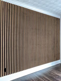 an empty room with wood paneling on the wall