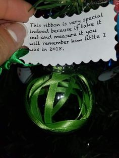 someone is holding a christmas ornament with a note attached to it that says, this ribbon is very special