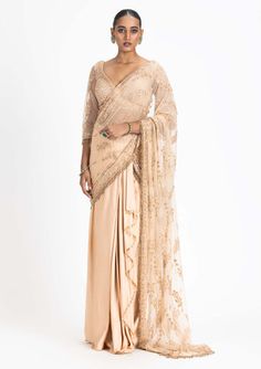 Step into the spotlight with our nude satin draped sari. This ensemble features a net-embroidered palla and blouse intricately adorned with tonal dori, highlighted with beads and crystals, adding a... Bollywood-style Draped Wedding Blouse Piece, Glamorous Pre-draped Saree With Resham Embroidery For Reception, Elegant Draped Organza Saree, Formal Festive Pre-draped Saree With Intricate Embroidery, Bollywood Style Draped Tissue Silk Dupatta, Pre-draped Tissue Silk Saree With Dupatta, Traditional Pre-draped Saree With Pearl Embroidery For Evening, Tissue Silk Pre-draped Saree For Wedding, Pre-draped Tissue Silk Saree For Wedding